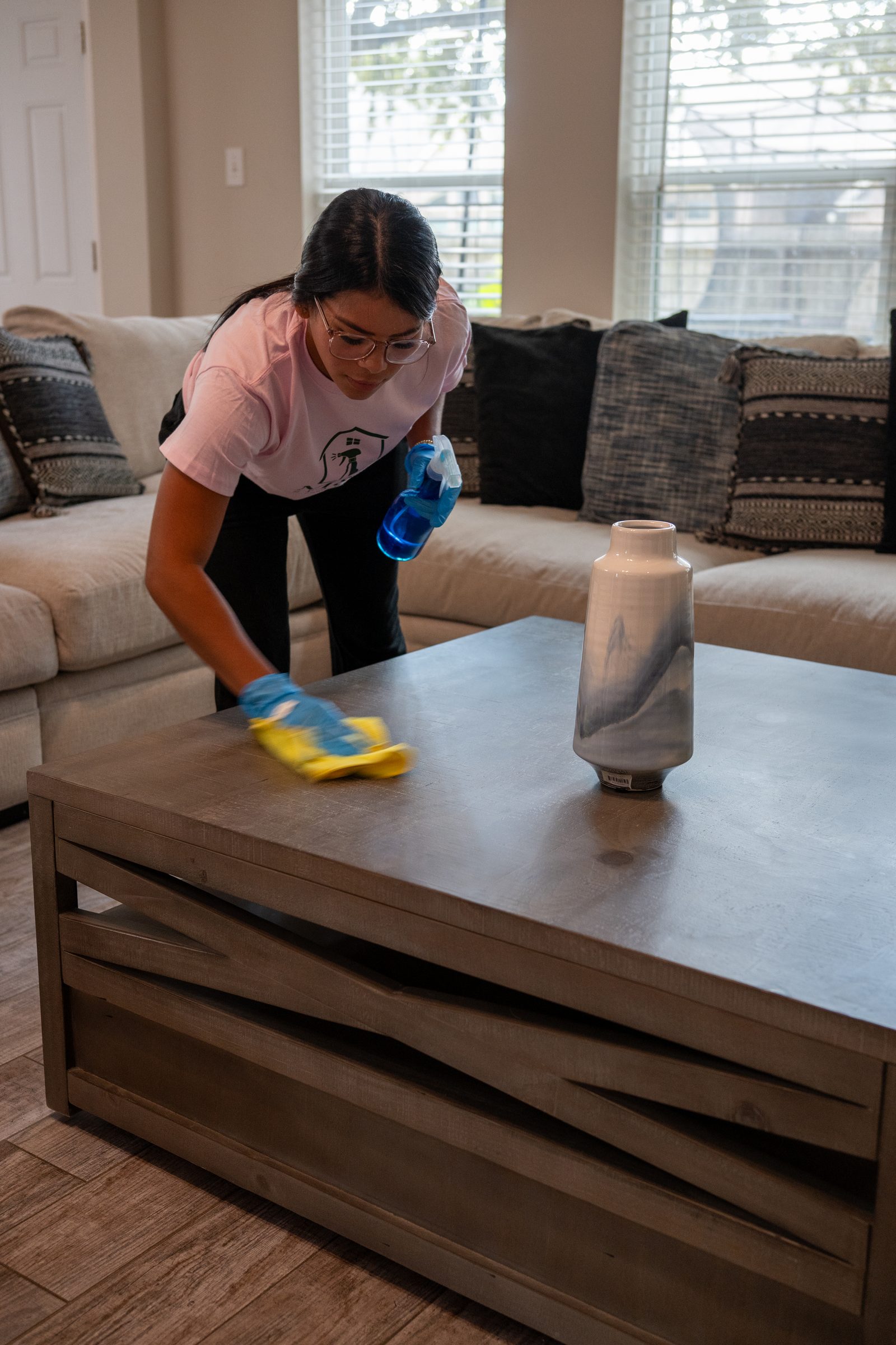 Wiping a wood table with a finish-aware cloth